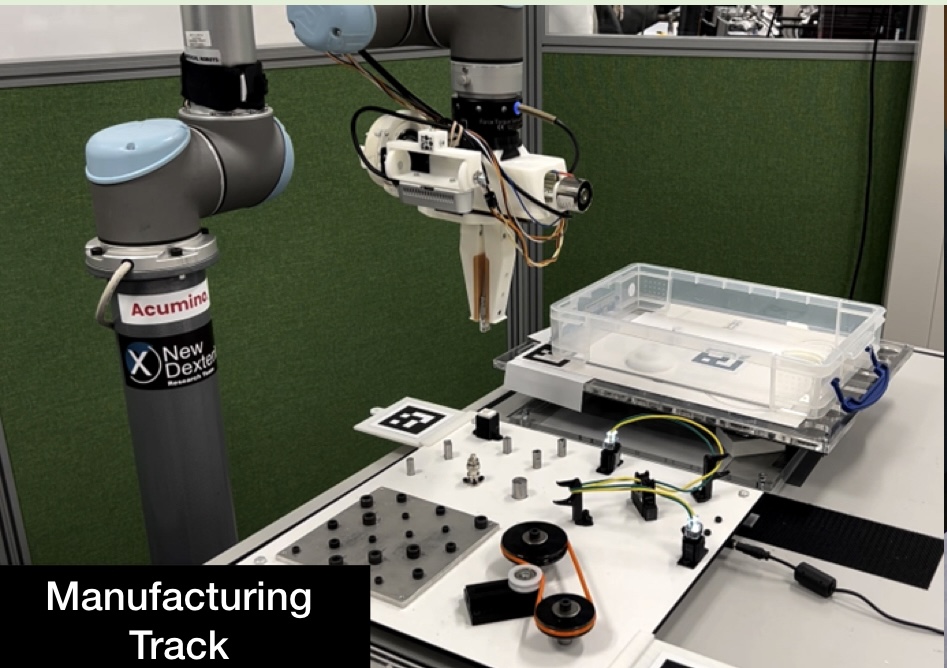 RGMC 8 at ICRA 2023: Manufacturing track setup showing robotic arm with gripper and component assembly area